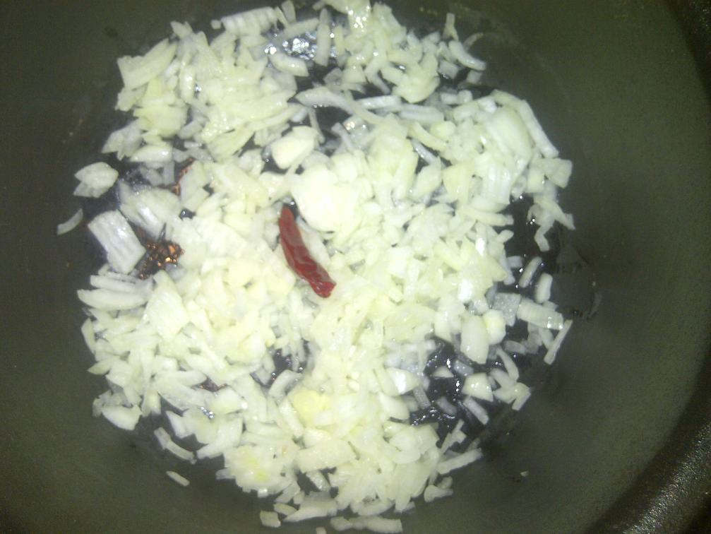Add chopped onions, chilli and 1 tbsp. of oil to your pot.